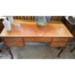 A mahogany dressing table with five fitted drawers raised on cabriole supports