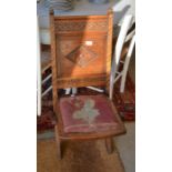 Carved oak folding chair with tapestry seat