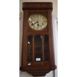 A German oak cased triple train wall clock