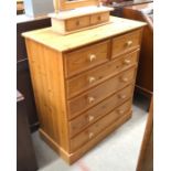 Modern pine chest of two short over four long drawers raised on a plinth base