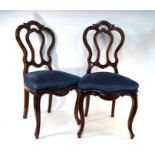 A set of six late 19th century walnut dining side chairs with overstuffed seats raised on cabriole