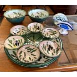 A glazed terracotta olive oil dipping set decorated with olive branches