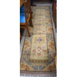 Turkish Milas runner with floral motif on camel ground with light blue border