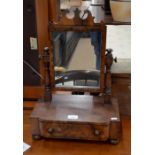 A Victorian fret cut flame mahogany toilet mirror on shaped platform base with single drawer and