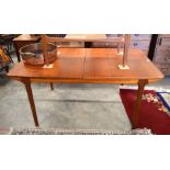 G Plan style 1960's teak extending dining table with two central butterfly action leaves, raised