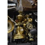 A box of assorted brass ware to include; horse brasses, adjustable table lamp, oil lamp etc.