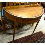 A 19th century satin inlaid demi lune card table with folding top raised on tapering square supports