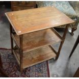 A rectangular oak three tier side table