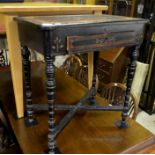 A Victorian ebonised table, folding top with fitted interior and frieze drawer raised on turned