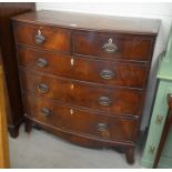 A Georgian mahogany bowfront chest of two short over three long drawers with brass handles raised on