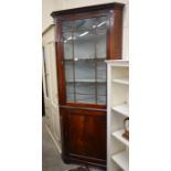 George III mahogany floor standing corner cupboard in two sections, with a glazed door over a