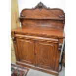 A Victorian flame mahogany chiffonier with raised back over single cavetto drawer and panelled