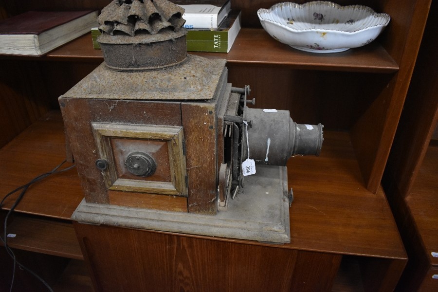 A vintage brass and mahogany magic lantern, to/w a pierced brass fender (2)