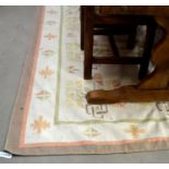 A kelim style flat weave cream ground rug with geometric floral motif and narrow brown border 273