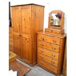 A 'St Michael Furniture' stained pine bedroom suite comprising a wardrobe with panelled doors,