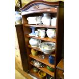 A modern open bookcase with arched top over five adjustable shelves raised on bracket feet