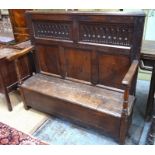 A part late 17th/18th century carved oak box settle, the joint framed with panelled back over a