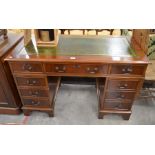 A reproduction mahogany twin pedestal desk with gilt tooled green leather top over nine drawers,