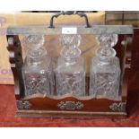 A mahogany three-bottle Tantalus with silver plated mounts (has no key but does open)