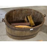 An oval coopered oak container with hooped iron handle containing two gilt framed pictures, a