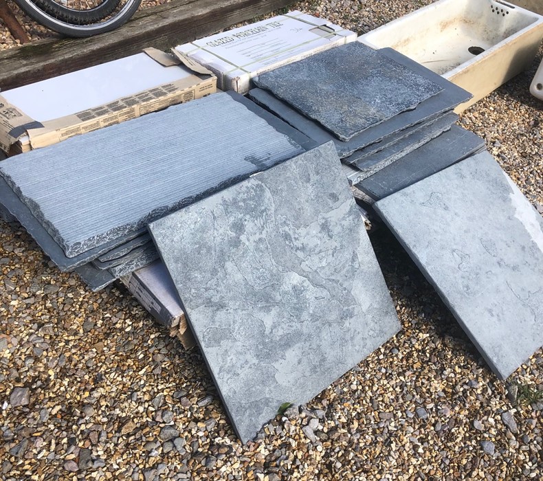 A mixed quantity of surplus slate/stone/porcelain flagstones/floor tiles