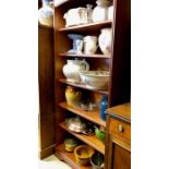 A bookcase of assorted china, glass and metalware including a washbowl, water jug, planters,