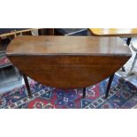Early 19th century oak drop leaf dining table on gateleg action turned supports with pad feet