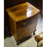 A small walnut bedside cupboard raised on shell carved cabriole supports