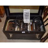 A case containing a quantity of assorted old photographic studio lighting etc