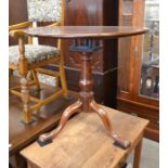 A George III mahogany tripod table, the circular birdcage mounted tilt-top raised on a turned column