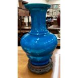 A Chinese turquoise blue monochrome vase with trumpet neck and unglazed base (rim chip) height 38cm