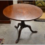 A 19th century occasional table, the circular tilt-top raised on a turned column and triform