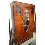 A mahogany inlaid wardrobe with glazed fret cut panels and central oval mirrored door over single