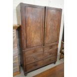 A Regency mahogany linen press with gilt mounted panelled doors over a base with two short and two