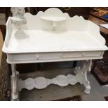 An antique painted pine wash stand with galleried back and two frieze drawers raised on shaped