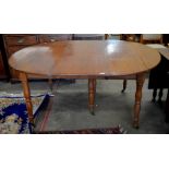 A 19th century French mahogany extending dining table, the extending drop leaf oval top with