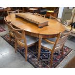 An American extending dining table crossbanded with burr walnut, the oval top with two central