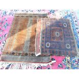 A Persian Baluch brown ground prayer rug to/w an antique Baluch saddle bag with brown and navy