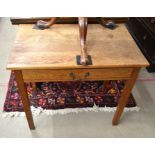 An early 20th century oak hall table with single frieze drawer, raised on square supports