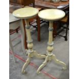 A pair of Continental painted jardiniere stands with circular tops on turned columns and scrolling