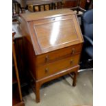 A small mahogany bureau, the panelled fall front enclosing a fitted interior over two long drawers