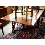 Oak extending draw leaf dining table on barley twist supports united by cross stretchers