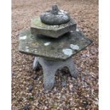 A Japanese stone pagoda style garden lantern to/with two stepping stone with two character