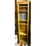 A pine narrow open bookcase with five adjustable shelves