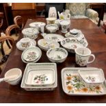 A large collection of Portmeirion oven to table wares, vases, bowls, watering can, table mats