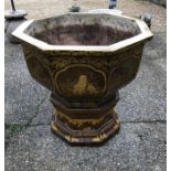 A large octagonal Japanese glazed terracotta garden urn, decorated with panels of animals in