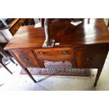 An Edwardian mahogany and ebony strung sideboard with central drawer and flanking cupboard doors