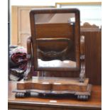 A Victorian mahogany toilet mirror on serpentine platform base with scroll feet