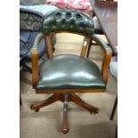 A mahogany framed green leather office swivel chair