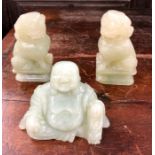 Three Chinese jade, or other, figures, comprising: a pair of Buddhist Lions; and a seated figure